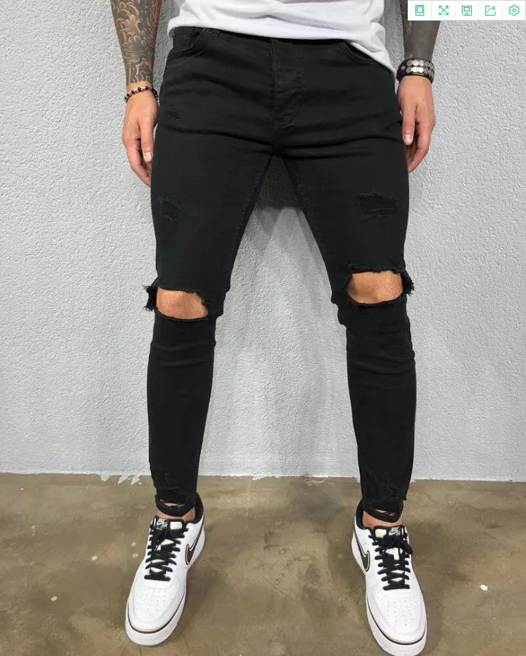 Men's skinny stretch denim jeans in black with ripped knee holes and tapered leg