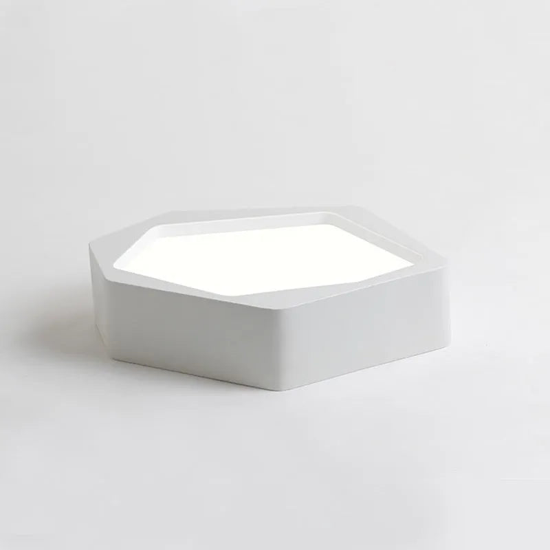 Black and white geometric shaped iron LED ceiling light on a ceiling, showing its special shape and modern design.