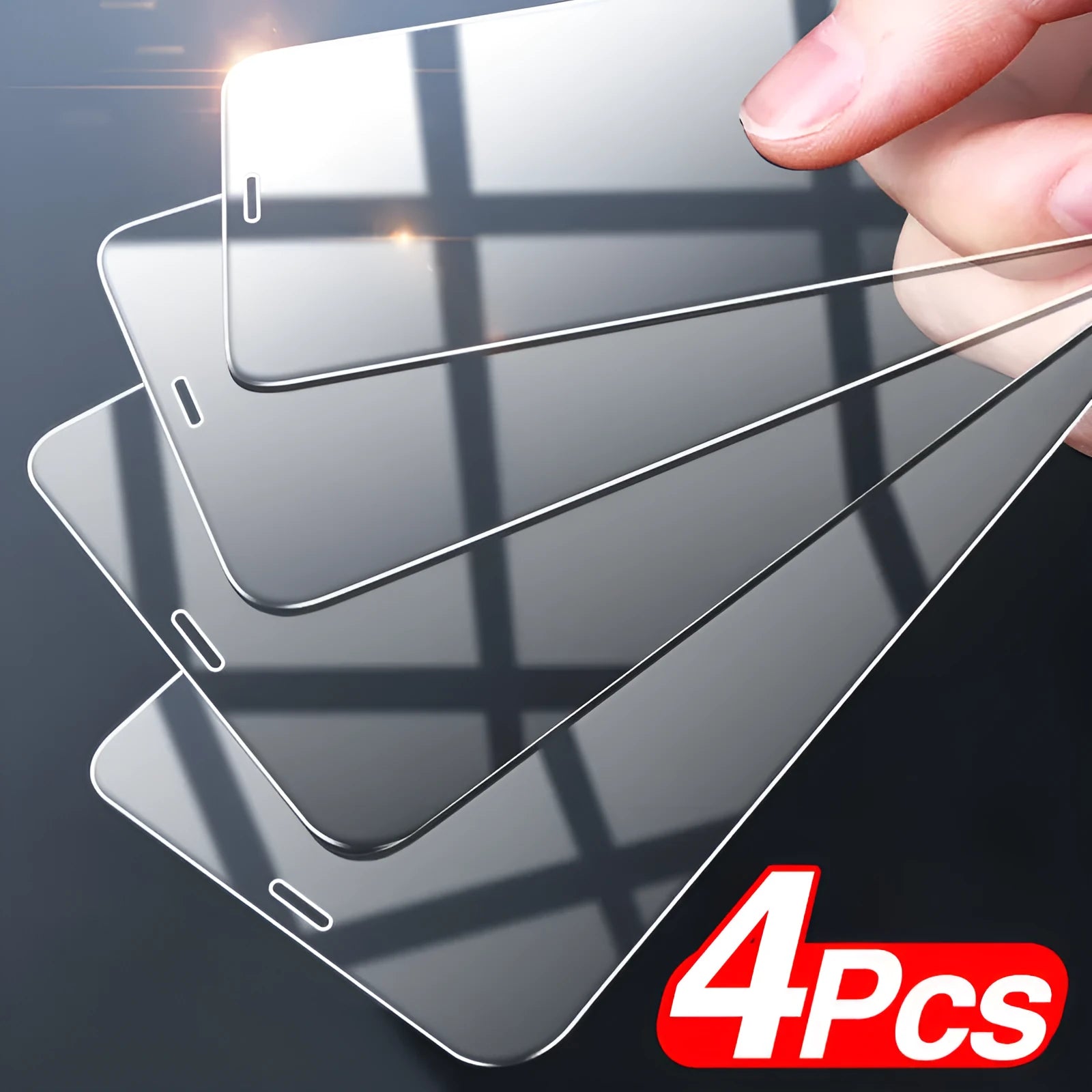 Four transparent tempered glass screen protectors for Apple iPhone models on a clean surface.