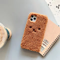 Brown embroidered plush cartoon bear face on a flexible TPU iPhone phone case.