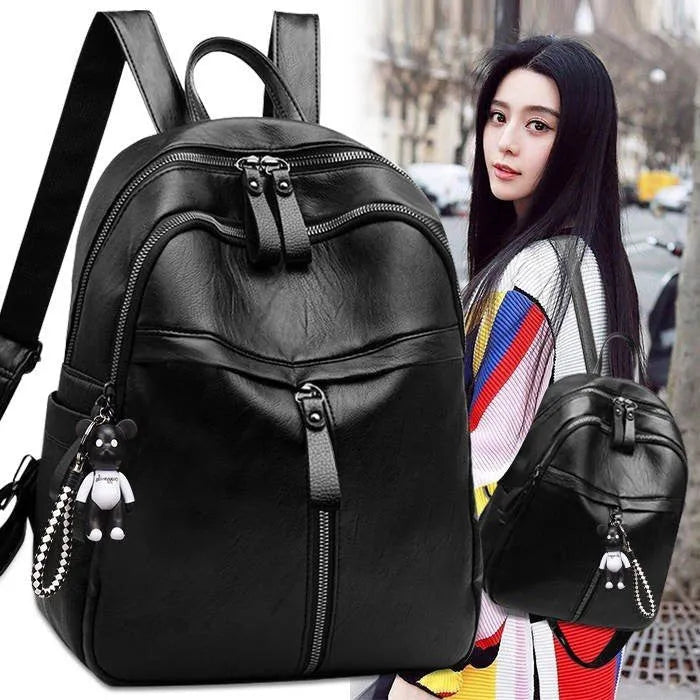 Black PU leather student backpack with double straps showing medium size and zipper opening