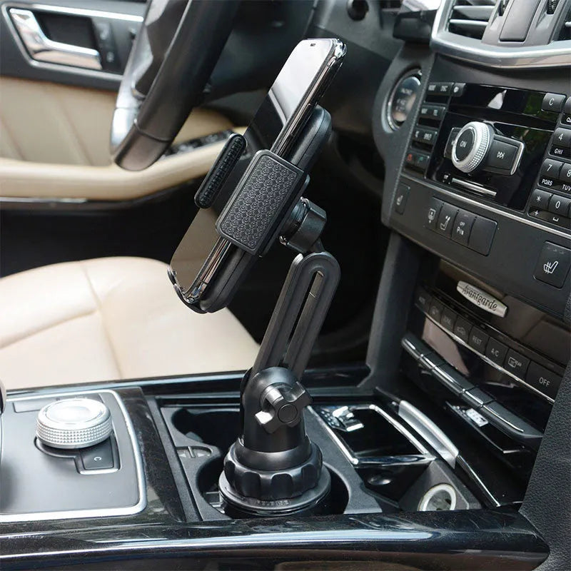 Black universal car dashboard phone holder with 360-degree rotating head and adjustable height on a car dashboard.