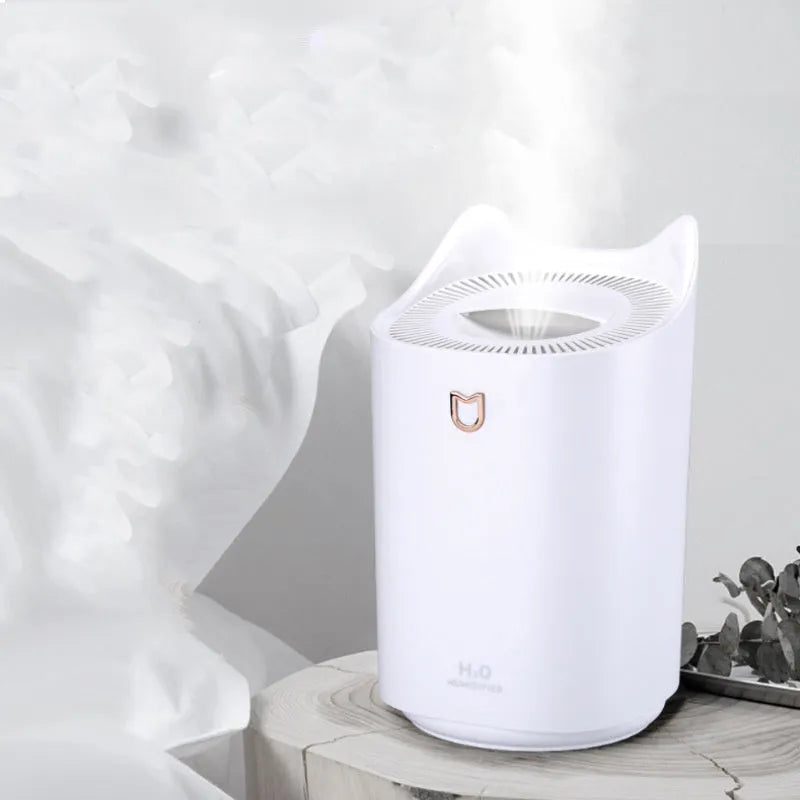 Coral pink USB humidifier with three fog outlets on bedside table