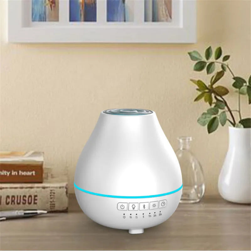 White round Bluetooth aroma diffuser humidifier with night light on a wooden surface.