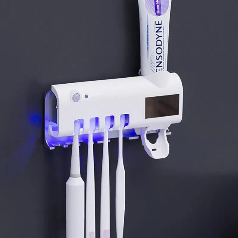 Black smart UV toothbrush steriliser and automatic toothpaste squeezer mounted on a bathroom wall.