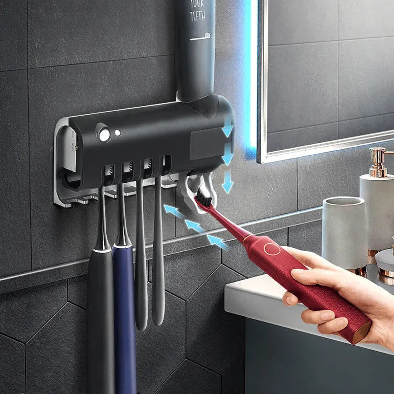 Black smart UV toothbrush steriliser and automatic toothpaste squeezer mounted on a bathroom wall.
