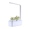 White hydroponic self-absorbent herb vegetable planting box with LED grow lights and water alarm on a desktop
