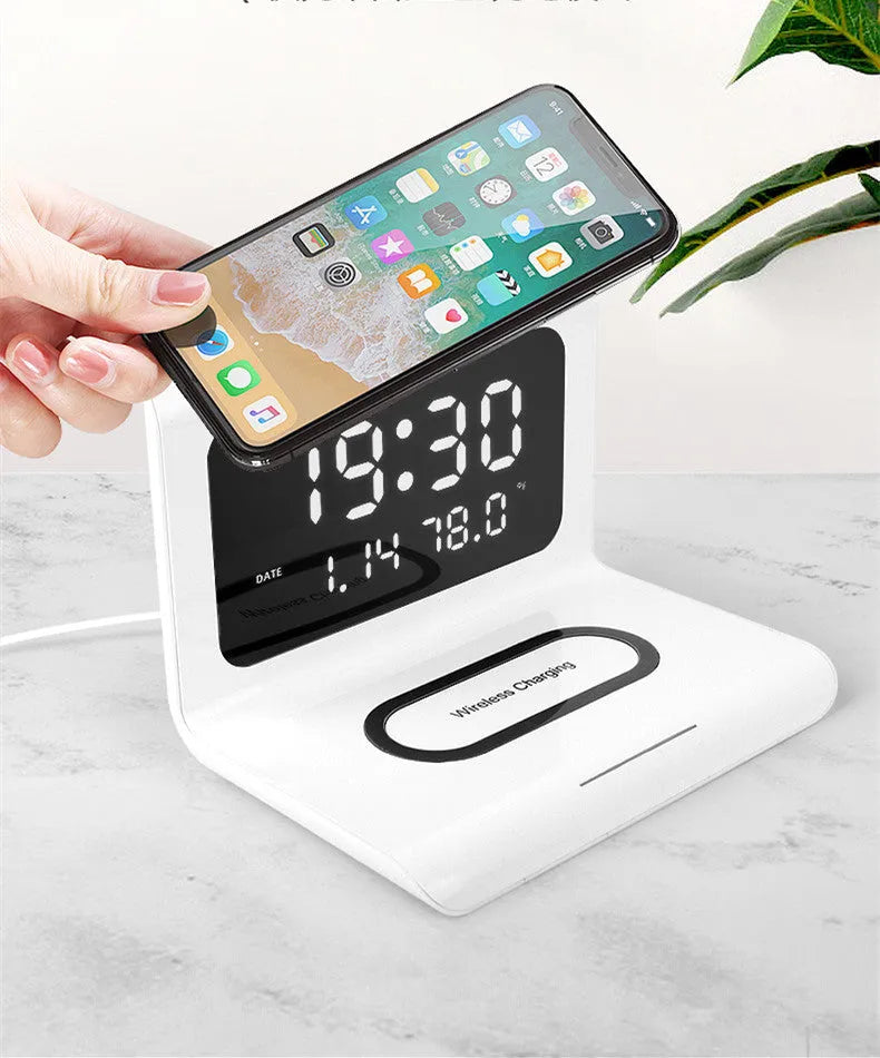 White or black wireless charger alarm clock with digital display showing time temperature humidity and 10W charging status
