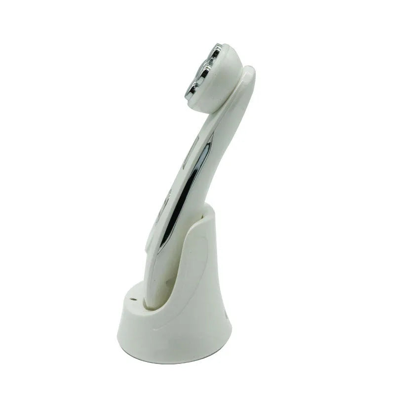 White multi-functional facial beauty instrument with LED colour light, acne needle, blackhead suction and shoveling machine attachments on table