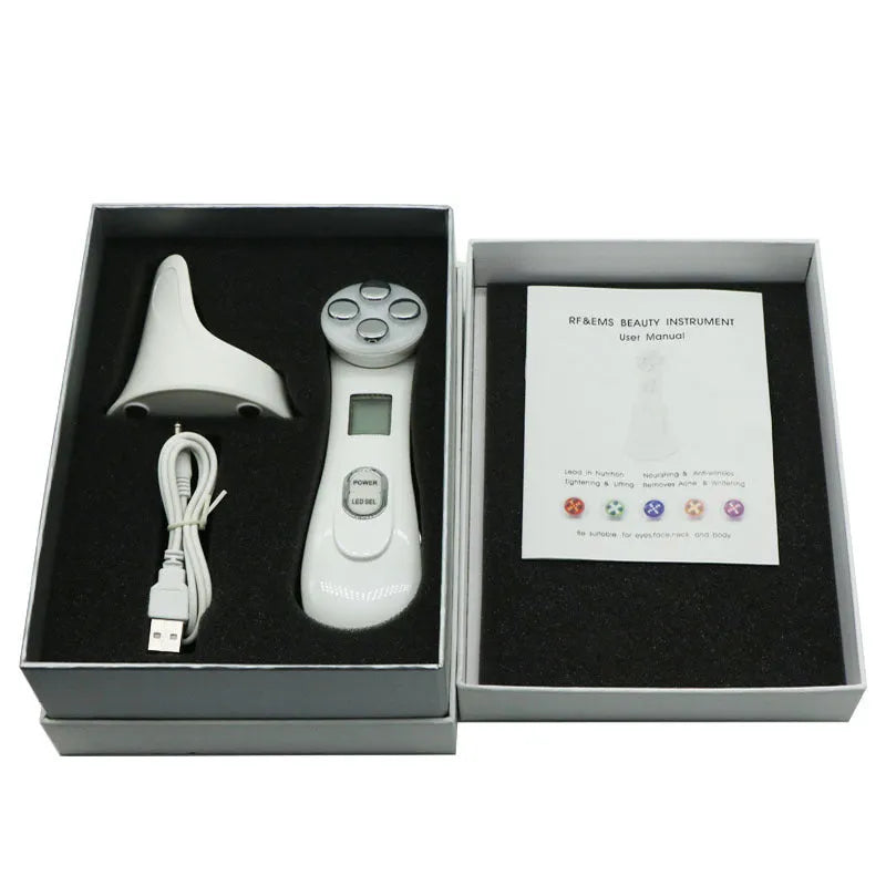 White multi-functional facial beauty instrument with LED colour light, acne needle, blackhead suction and shoveling machine attachments on table