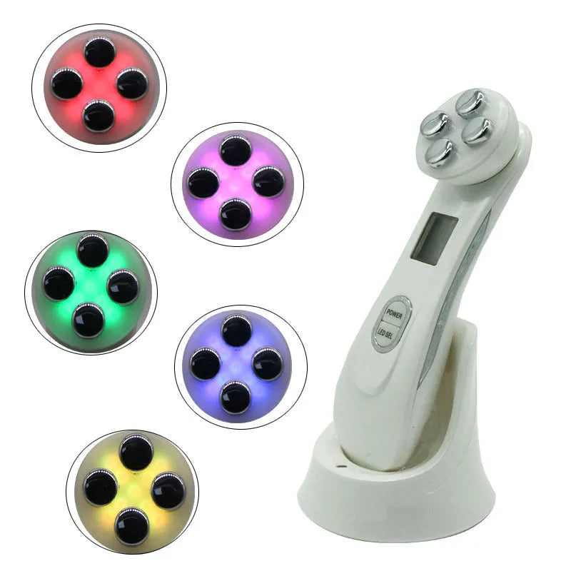 White multi-functional facial beauty instrument with LED colour light, acne needle, blackhead suction and shoveling machine attachments on table