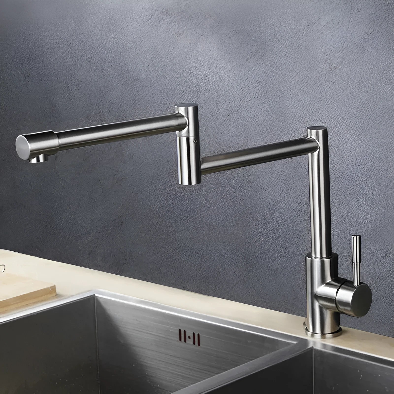Silver stainless steel kitchen tap with 360-degree rotating spout and dual hot and cold controls