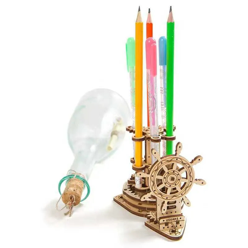 Ukrainian wooden rotating pen holder model with a steering wheel design on a desk.