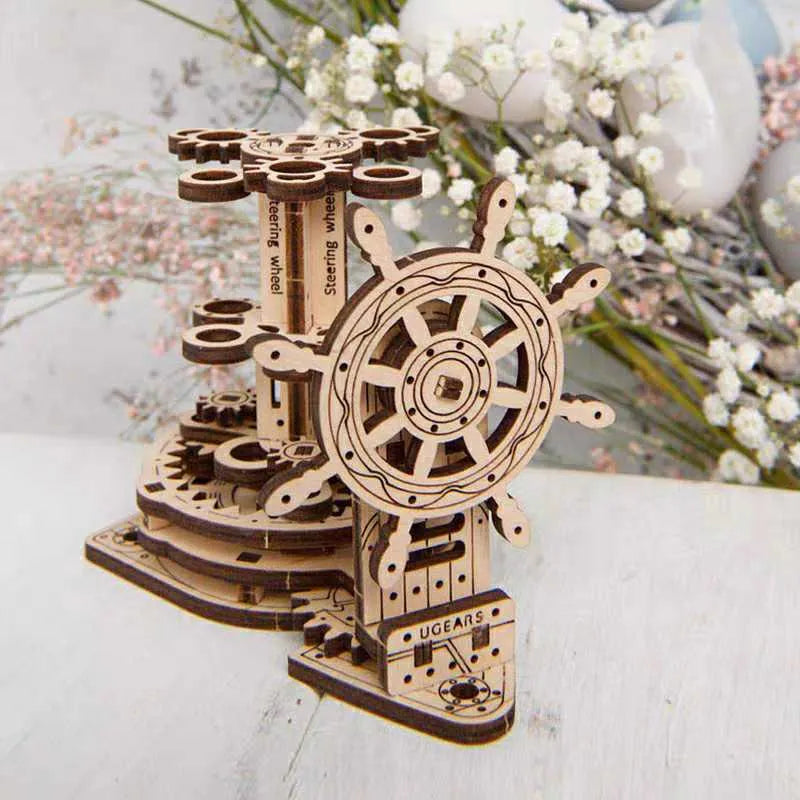 Ukrainian wooden rotating pen holder model with a steering wheel design on a desk.