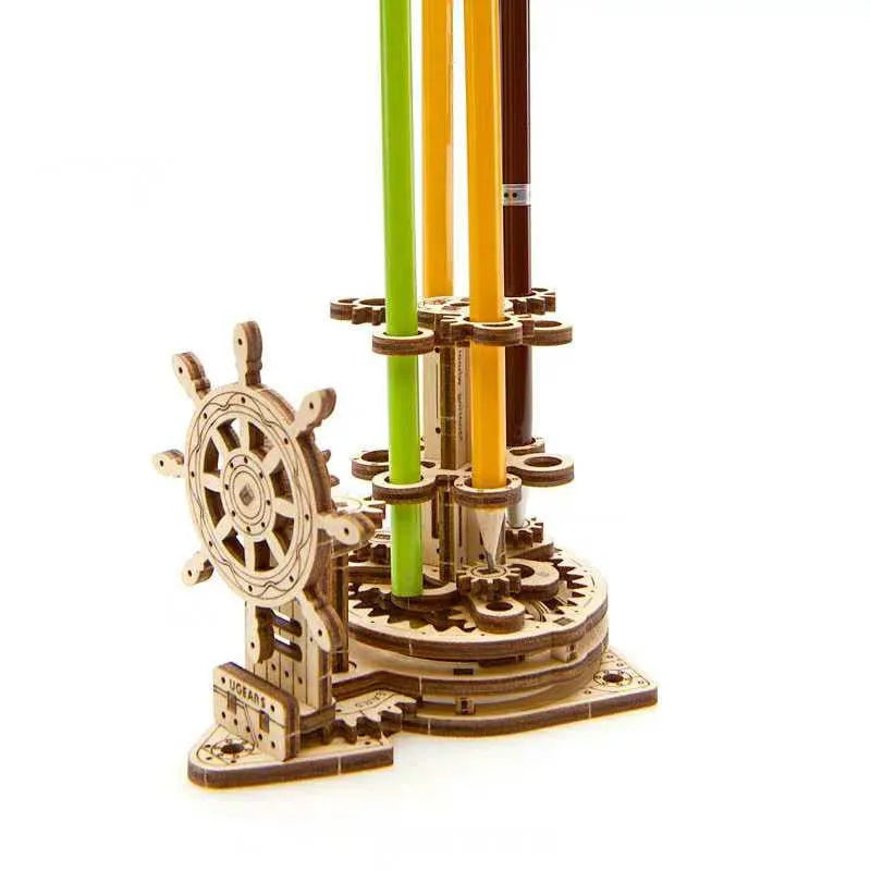 Ukrainian wooden rotating pen holder model with a steering wheel design on a desk.