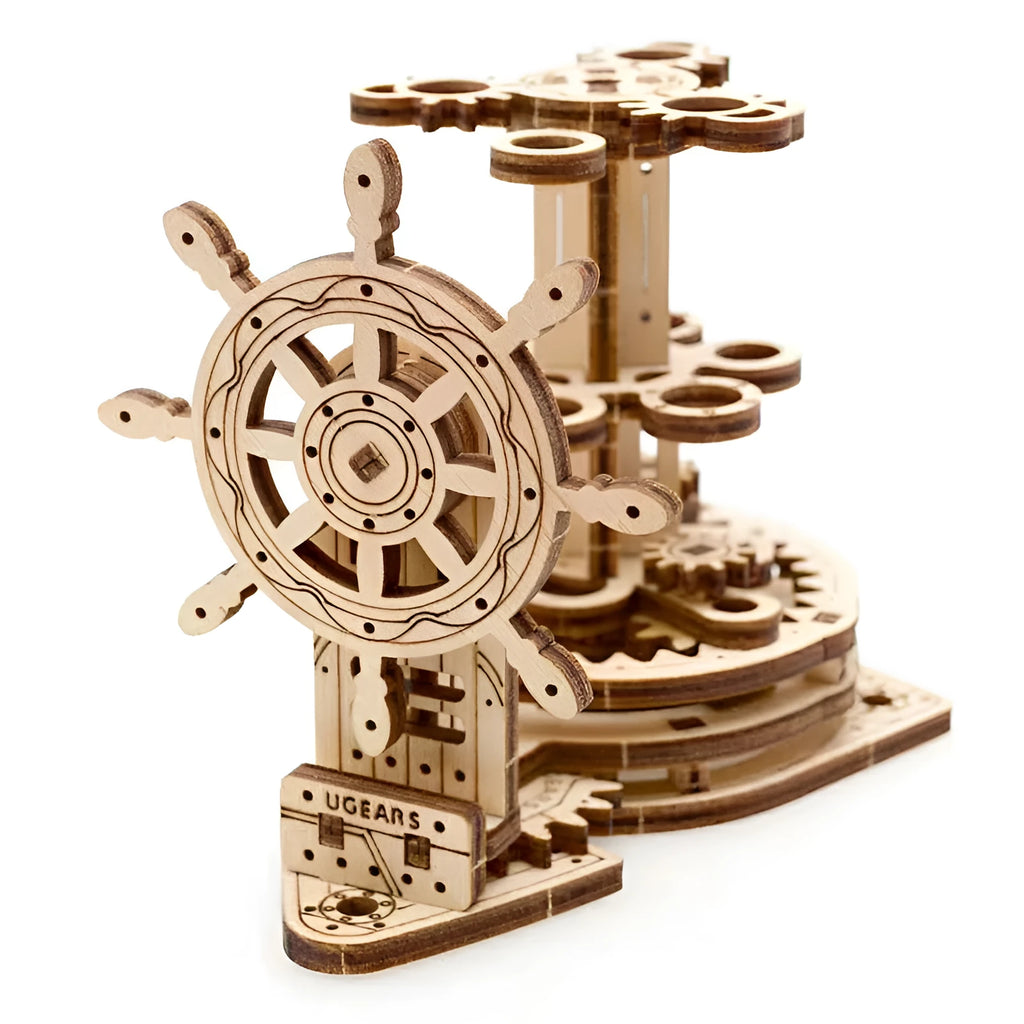 Ukrainian wooden rotating pen holder model with a steering wheel design on a desk.