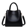 Women's medium bucket handbag in PU leather with litchi pattern, zipper closure, and internal organisation