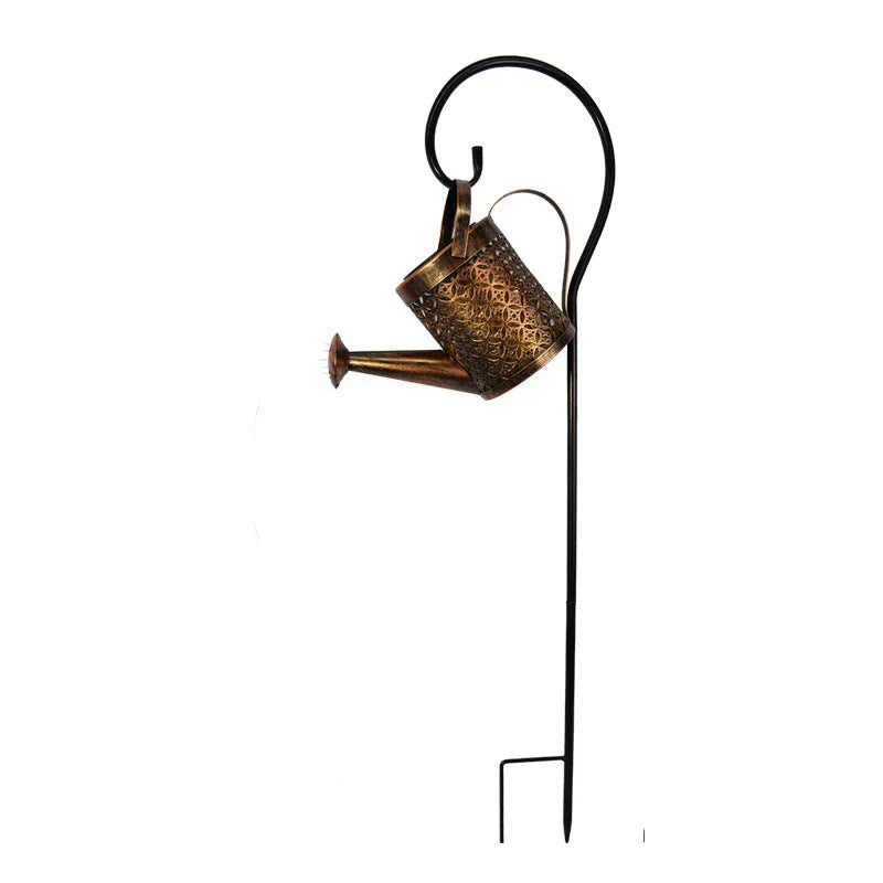 Solar watering can garden lamp with hollow-out iron shower body and 36 warm white LED lights on copper wire, installed in grass