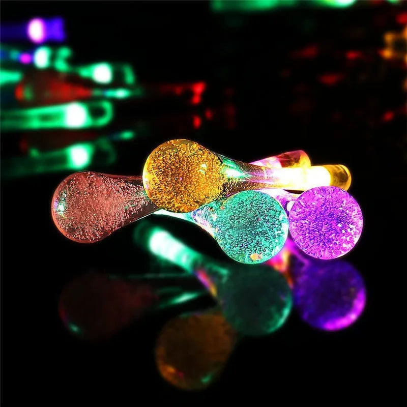 6.5 metre solar LED string lights with bubble drops pendants decorating an outdoor fence