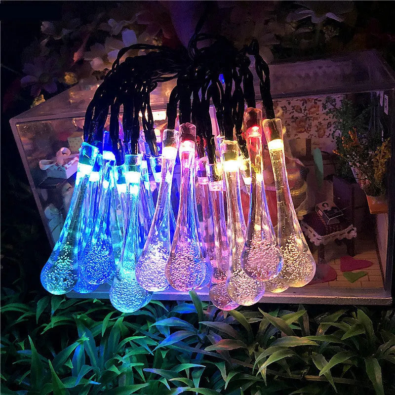 6.5 metre solar LED string lights with bubble drops pendants decorating an outdoor fence