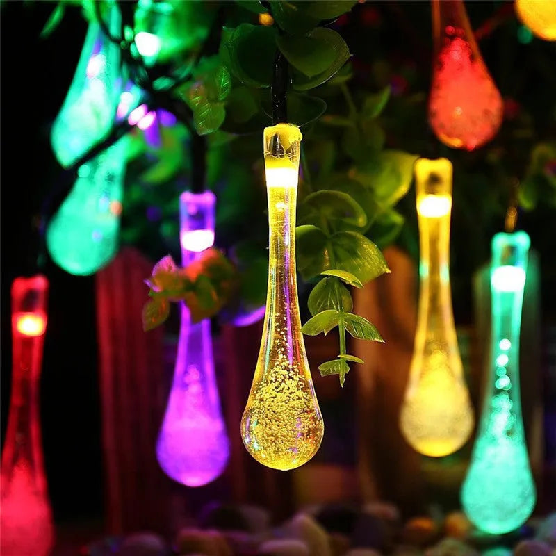 6.5 metre solar LED string lights with bubble drops pendants decorating an outdoor fence
