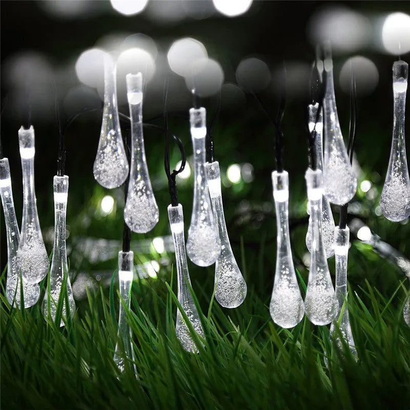 6.5 metre solar LED string lights with bubble drops pendants decorating an outdoor fence