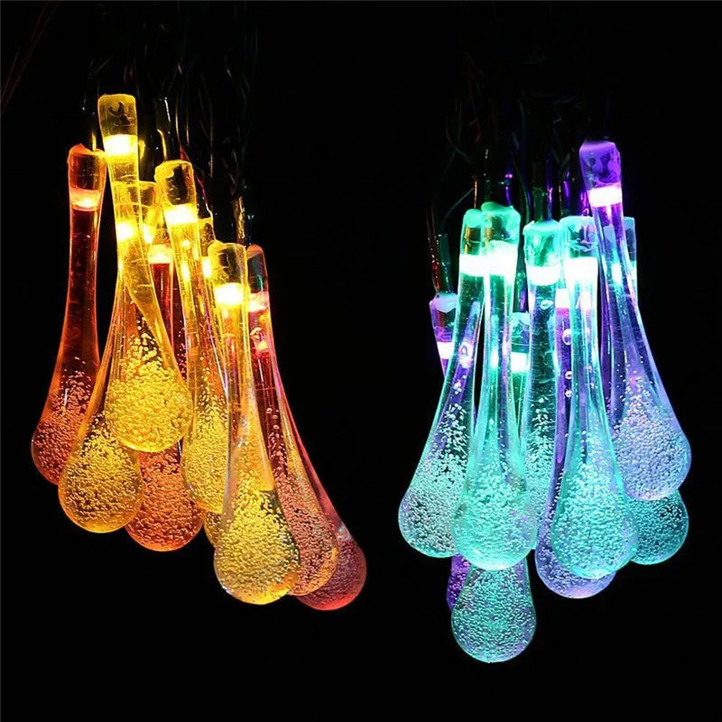 6.5 metre solar LED string lights with bubble drops pendants decorating an outdoor fence