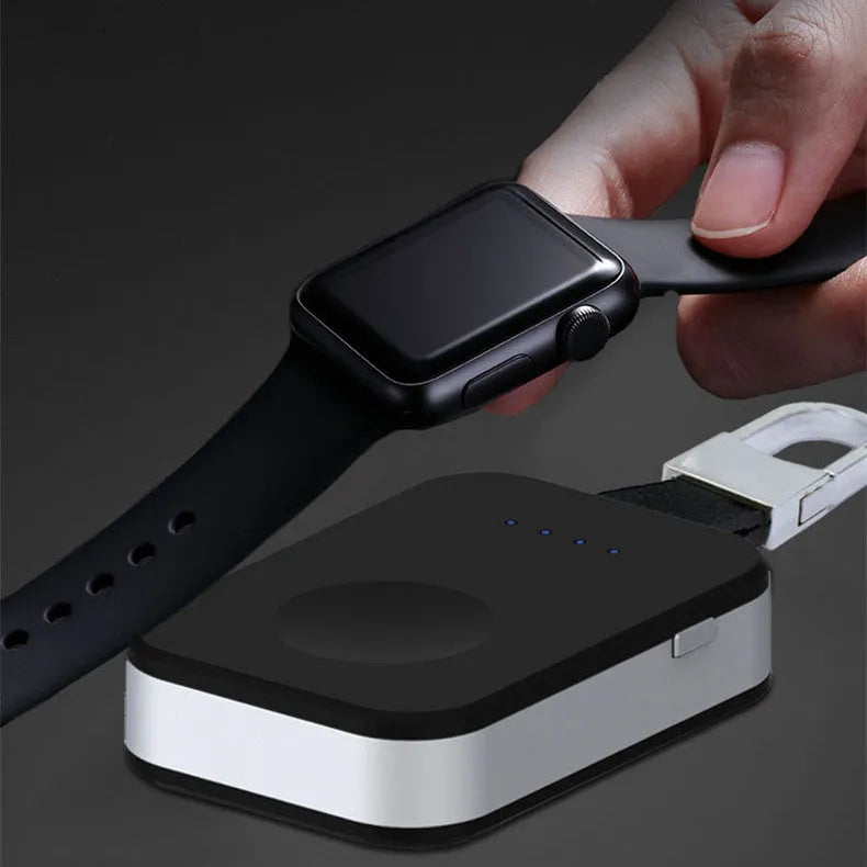 Black Apple Watch portable wireless charger keychain with keyring, shown next to an Apple Watch.