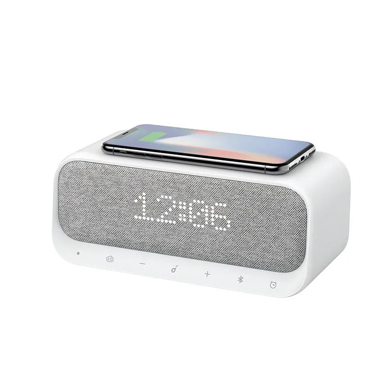 Anker Soundcore white or pink Bluetooth speaker alarm clock with wireless charging pad on top.