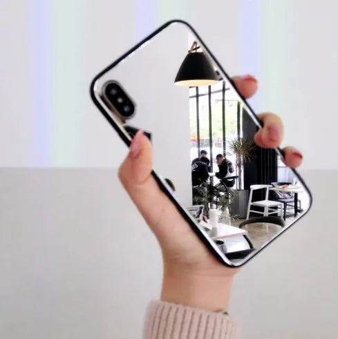 Black iPhone mirror phone case showing reflective back surface, compatible with multiple iPhone models.
