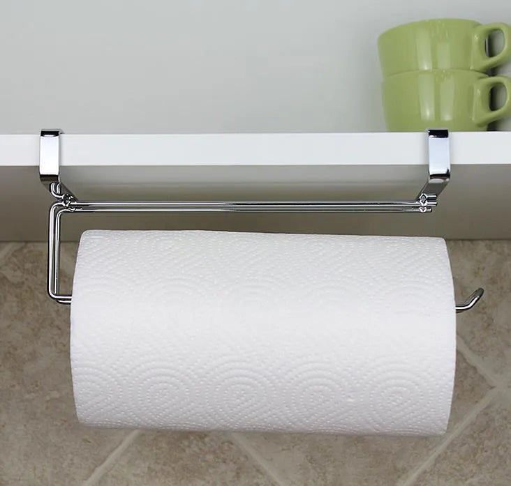 Silver stainless steel paper towel rack mounted on back of white cabinet door.