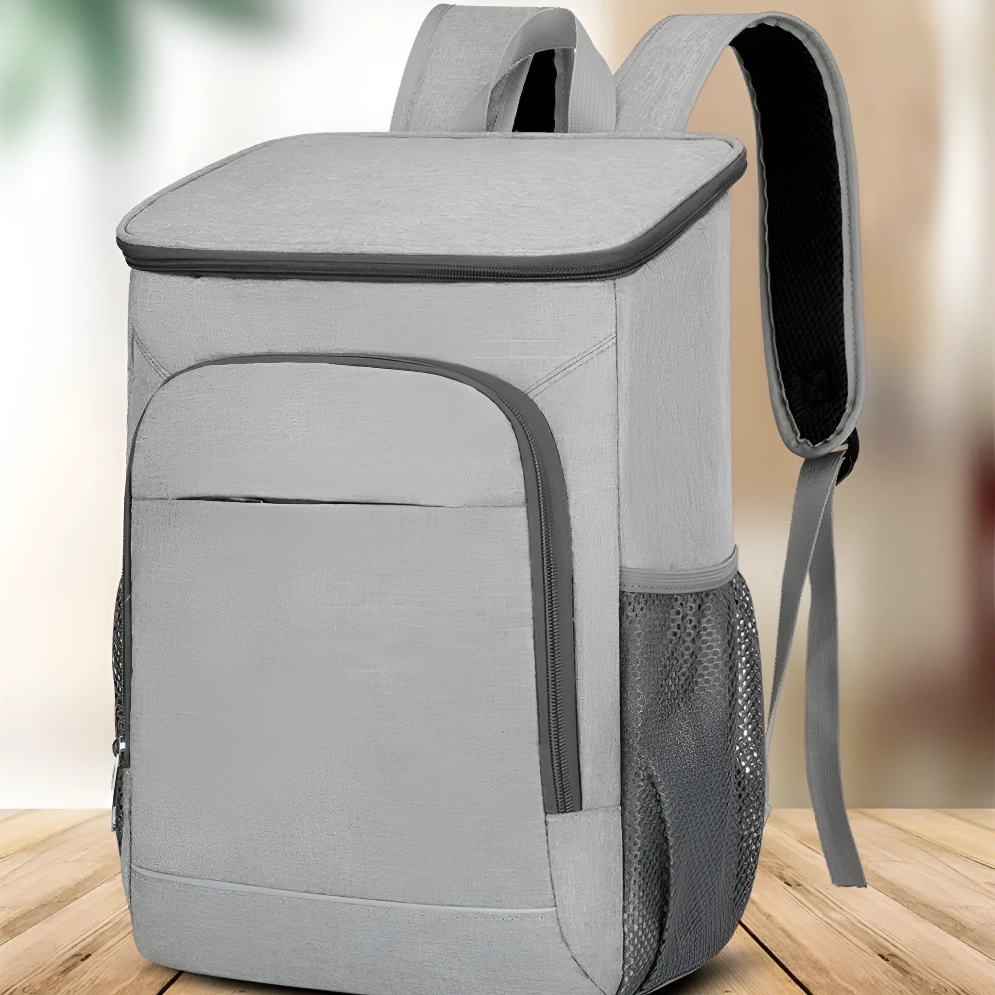 Large black outdoor thermal picnic backpack with curved shoulder straps on a gray background.