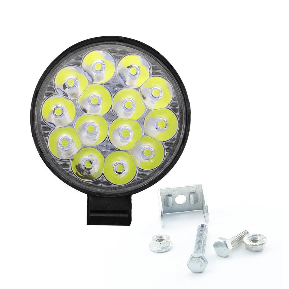 White aluminium LED work light with a round design, suitable for mounting on a vehicle.