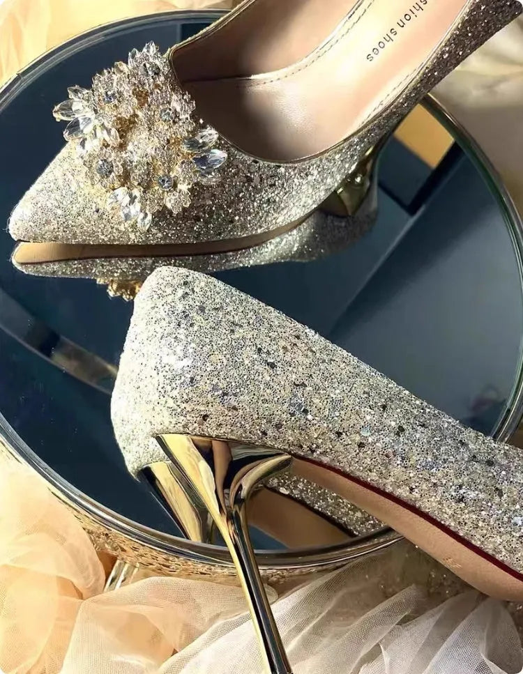 Champagne coloured pointed toe wedding heels with rhinestone floral detail on a fine heel.