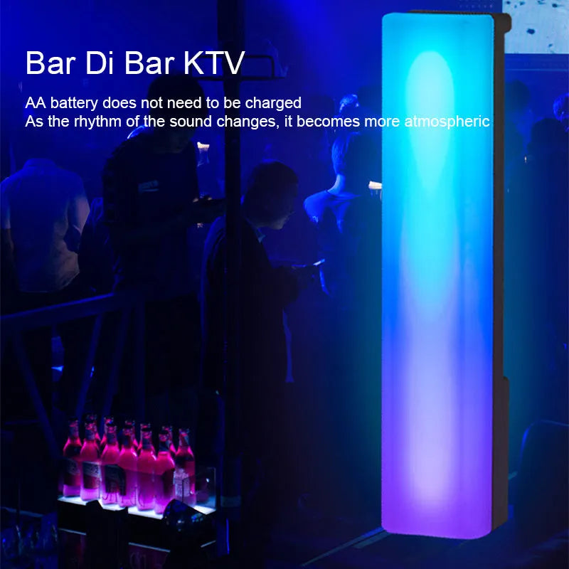 Black and white 3D RGB music rhythm ambiance lamp on a table with USB cable.