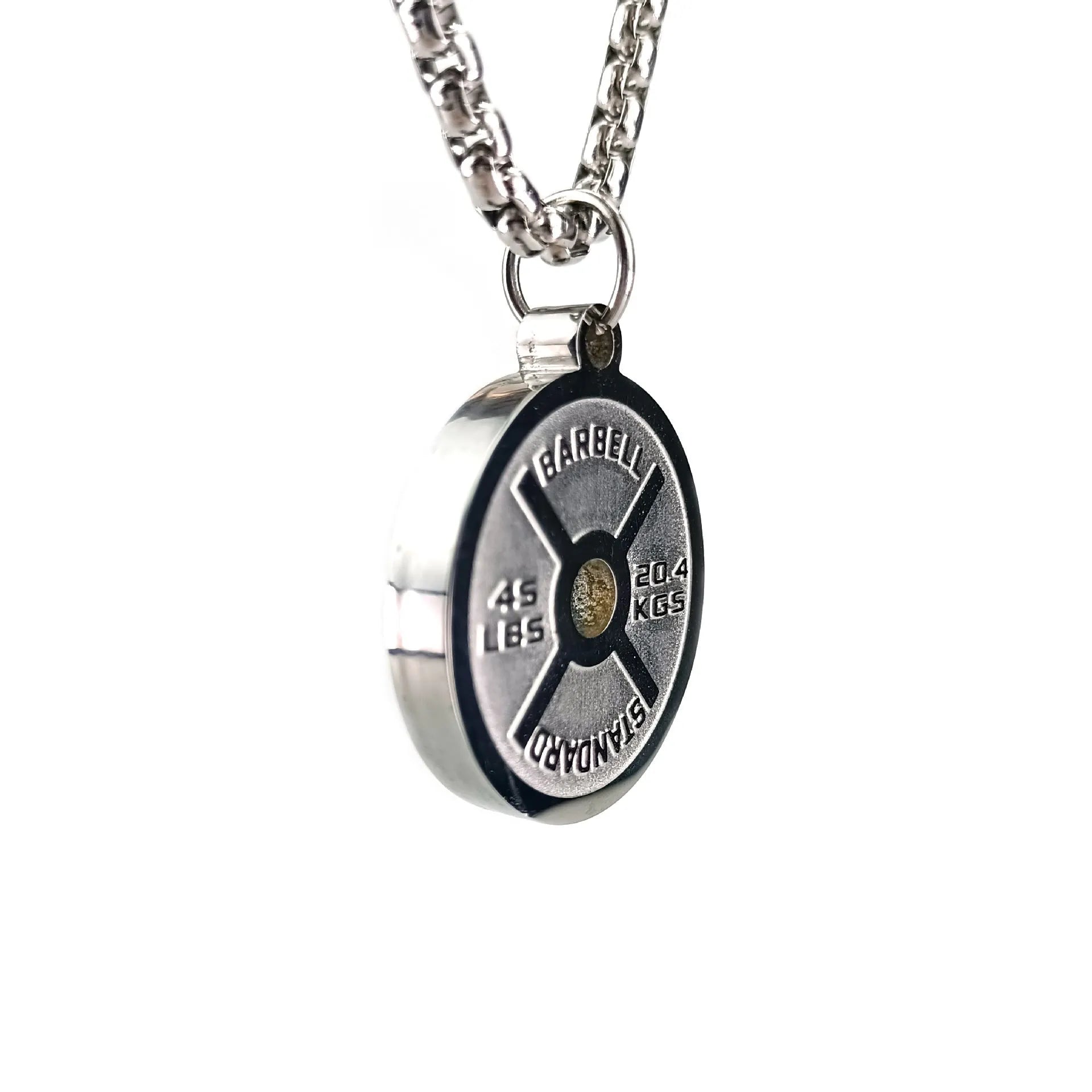 Polished stainless steel barbell disk geometric pendant necklace on a gold chain.