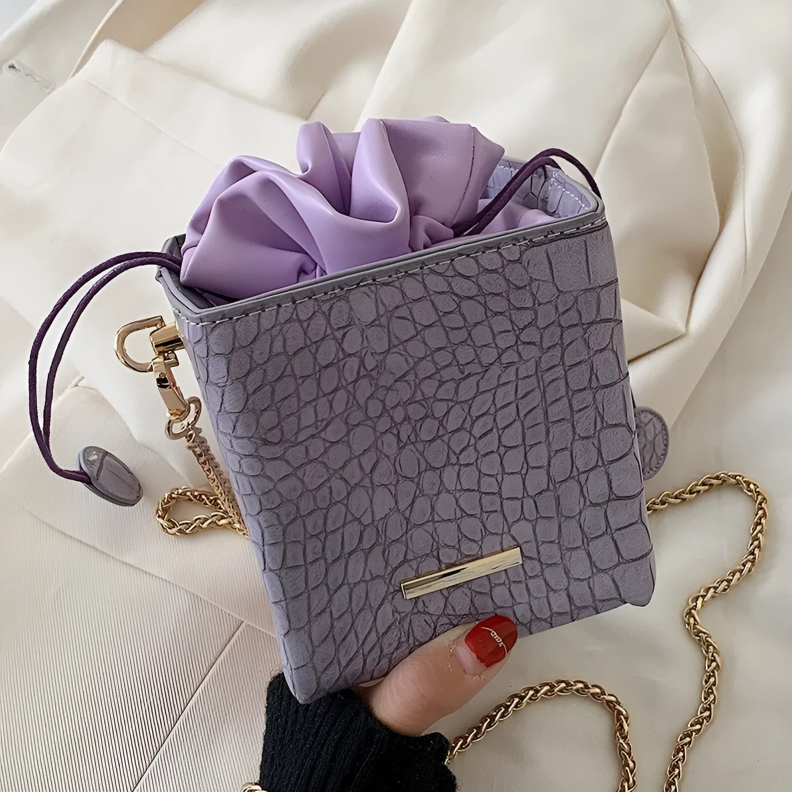 Small women's messenger bag with chain accents in six colour options including black green pink purple white yellow