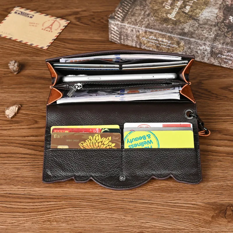 Women's brown leather tri-fold wallet with embossed Chinese floral pattern showing interior compartments