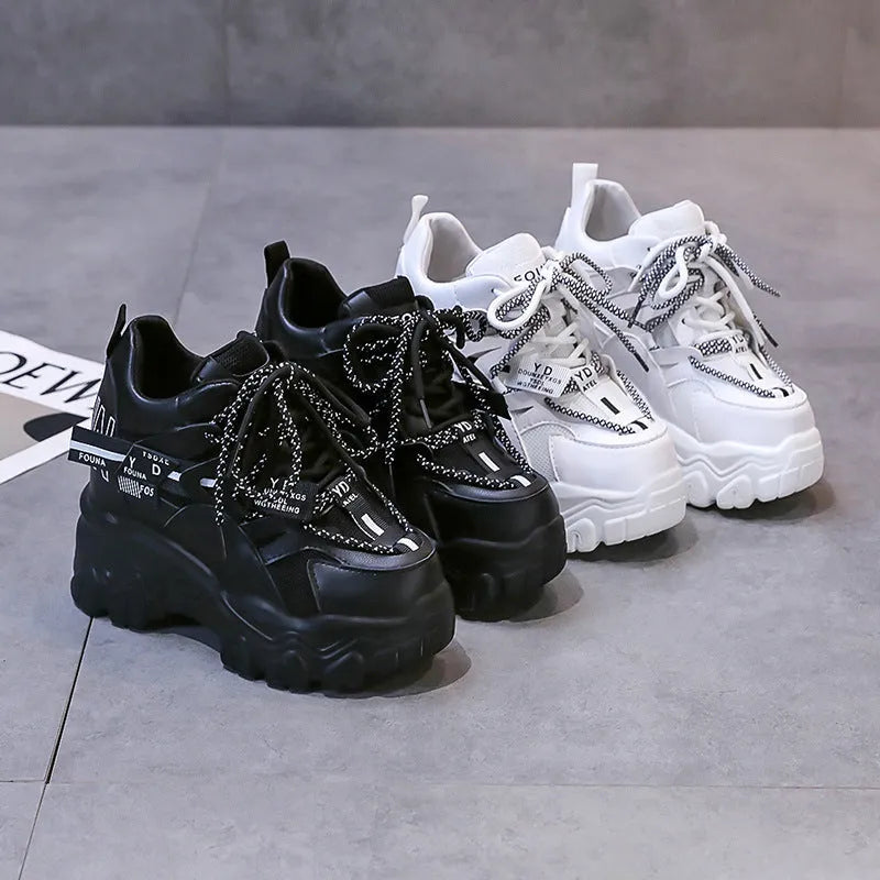 Women's white mesh platform sports shoes with cross strap and round toe on rubber sole.