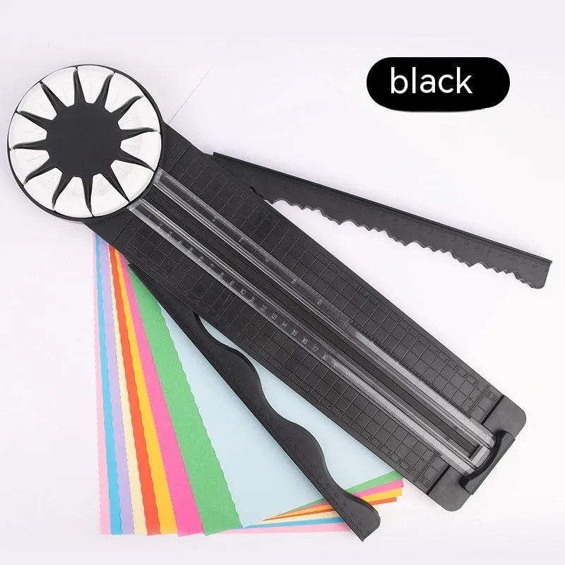 Pink and black 12-in-1 multifunctional plastic paper cutter with dotted guides on a cutting mat.