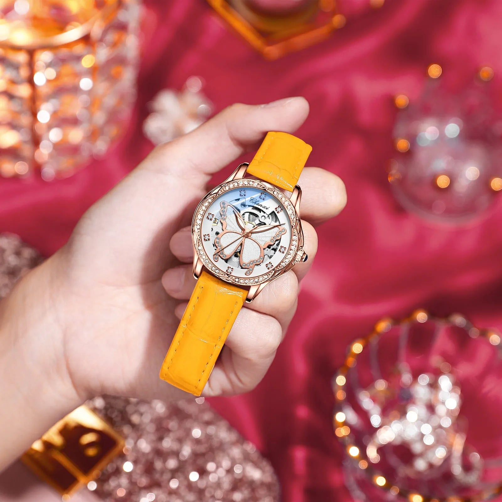 Butterfly dial diamond-embedded women's automatic mechanical watch with genuine leather strap and pin buckle on a white background