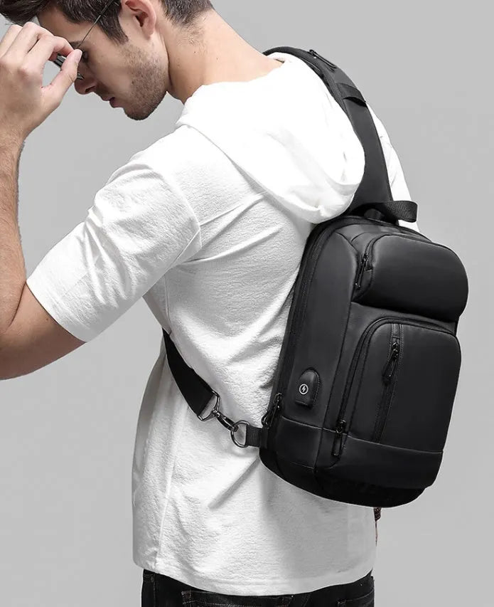 Black PVC outdoor leisure shoulder bag with air cushion strap and internal organisers