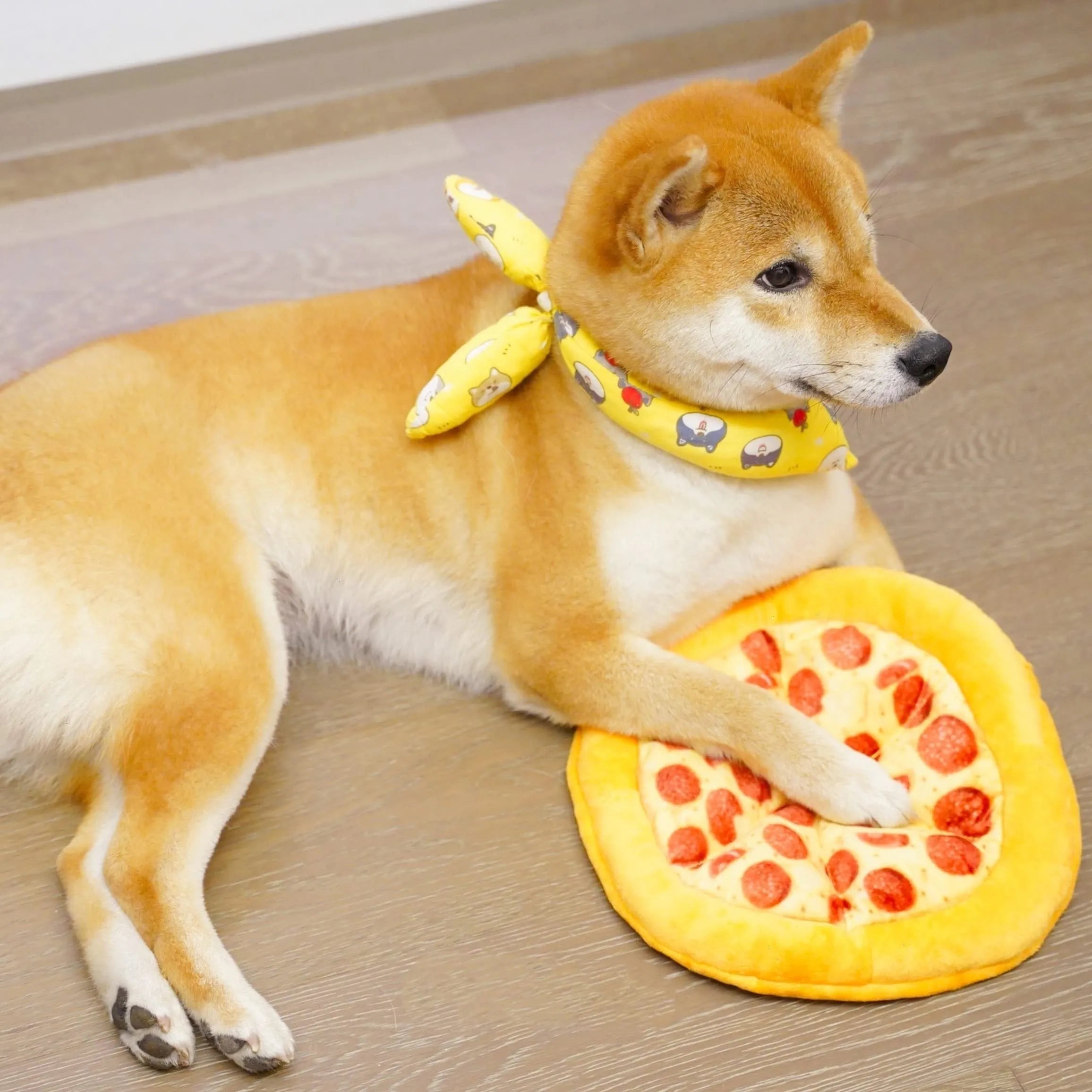 Yellow pizza slice dog chew toy with teddy bear design on top