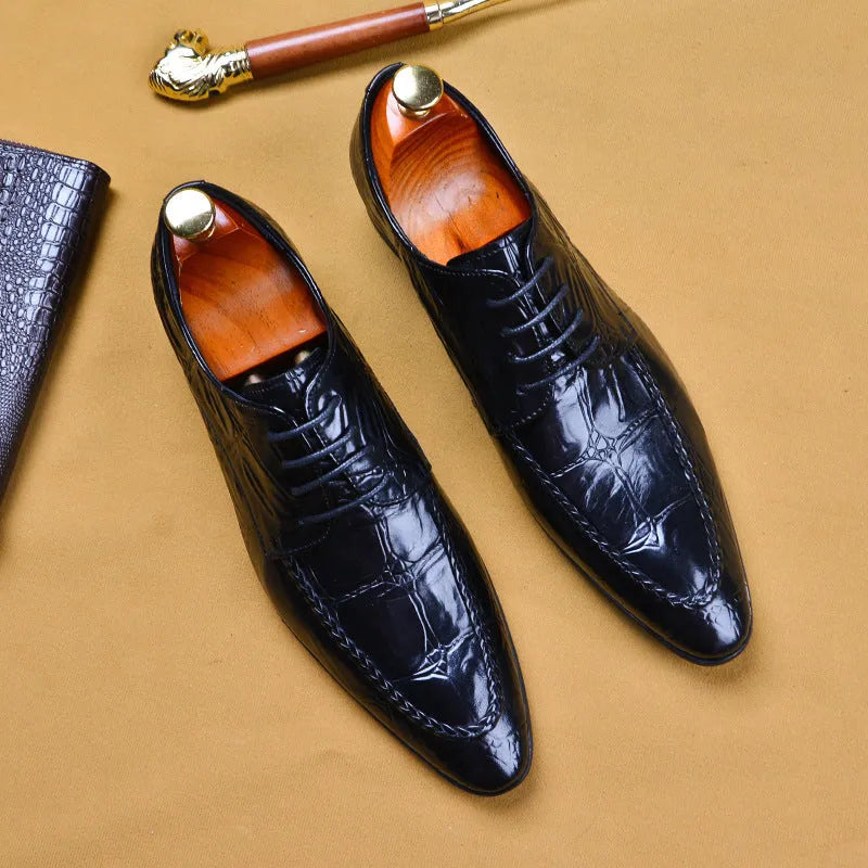 Men's black leather formal shoes with alligator pattern texture and a horse bit buckle detail.