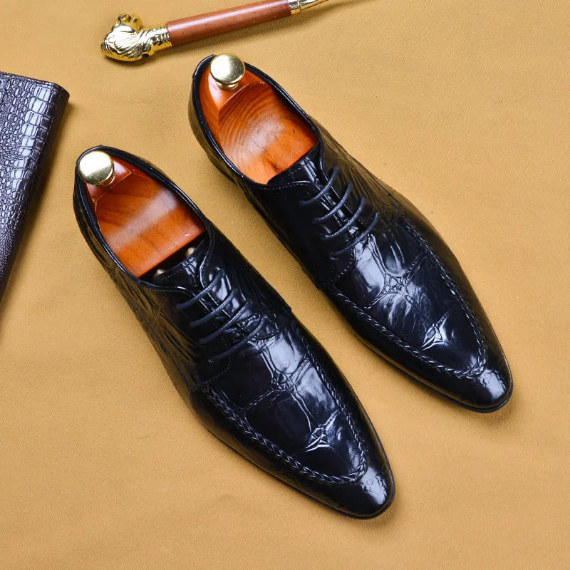 Men's black leather formal shoes with alligator pattern texture and a horse bit buckle detail.