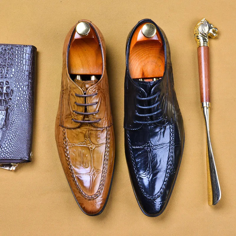 Men's black leather formal shoes with alligator pattern texture and a horse bit buckle detail.