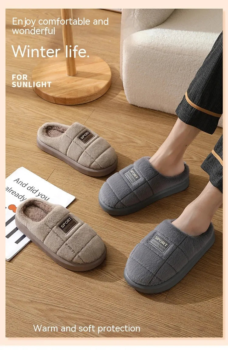 Men's grey and brown plaid rabbit hair winter slippers with a thick sole on a wooden floor.