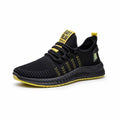 Men's black casual trainers with cross strap design on a flying weave upper.