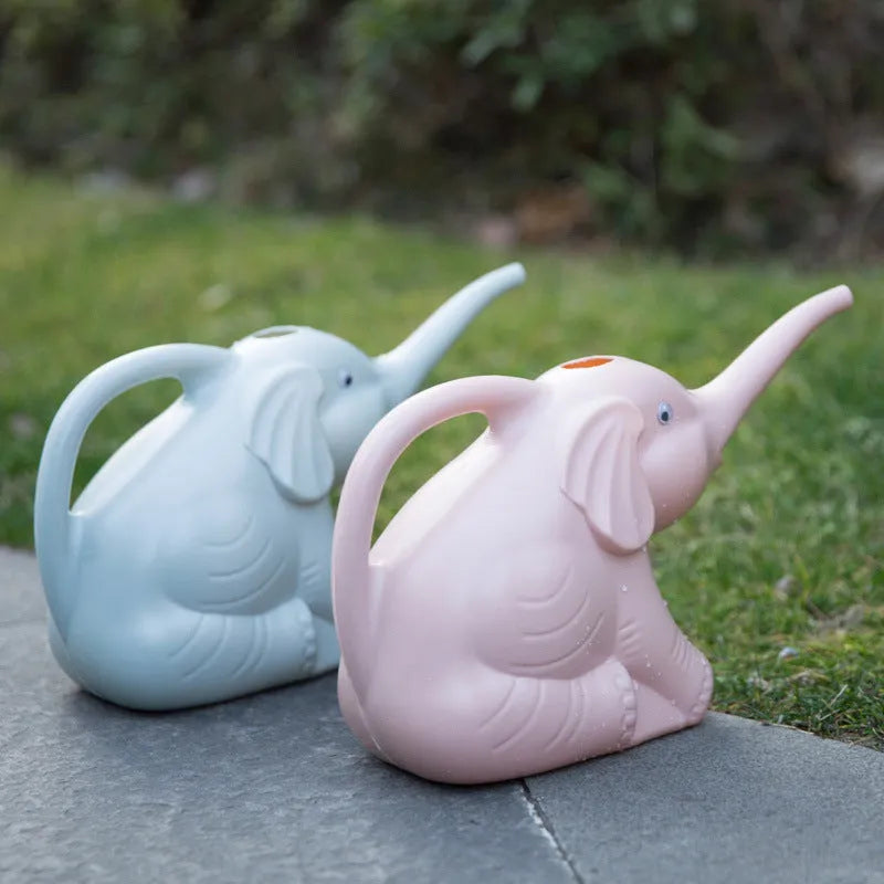 Pink children's watering can shaped like a sitting baby elephant with a long spout.