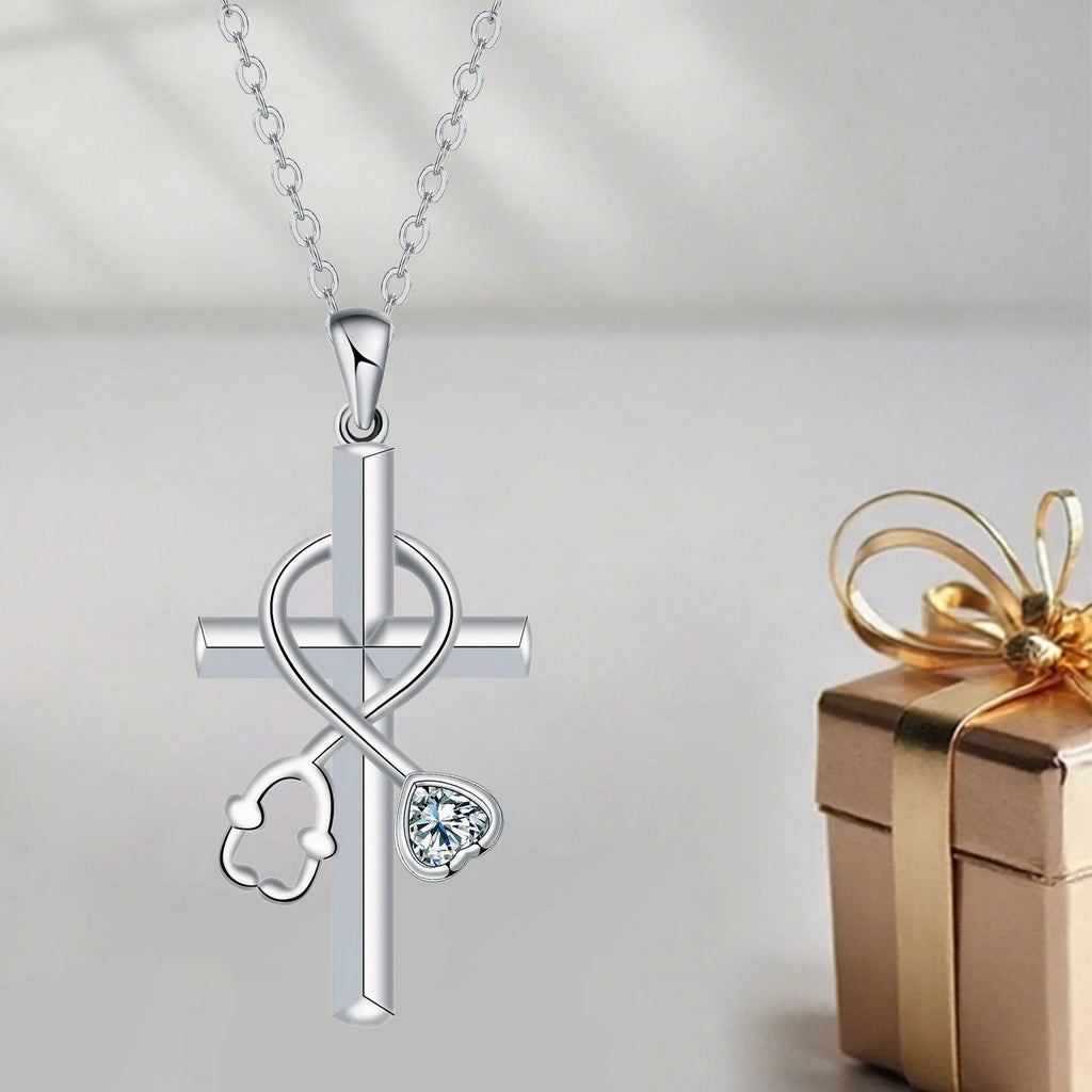Silver-coloured women's necklace with a pendant shaped as a cross combined with a stethoscope.